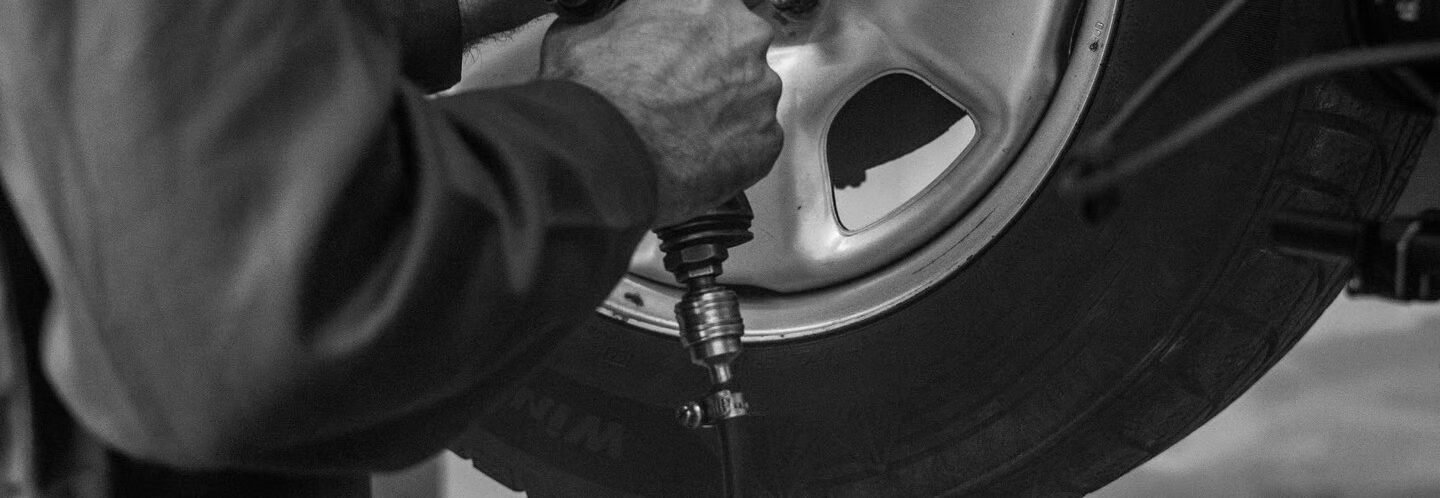 Technician working on a car wheel