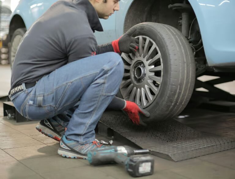 Technician installing a wheel in the shop